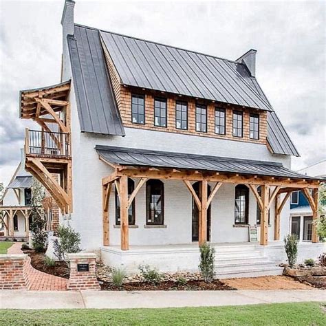 white brick house with black metal roof|pictures of brick house roofs.